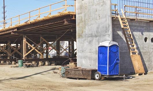 row of porta potties on a busy work site